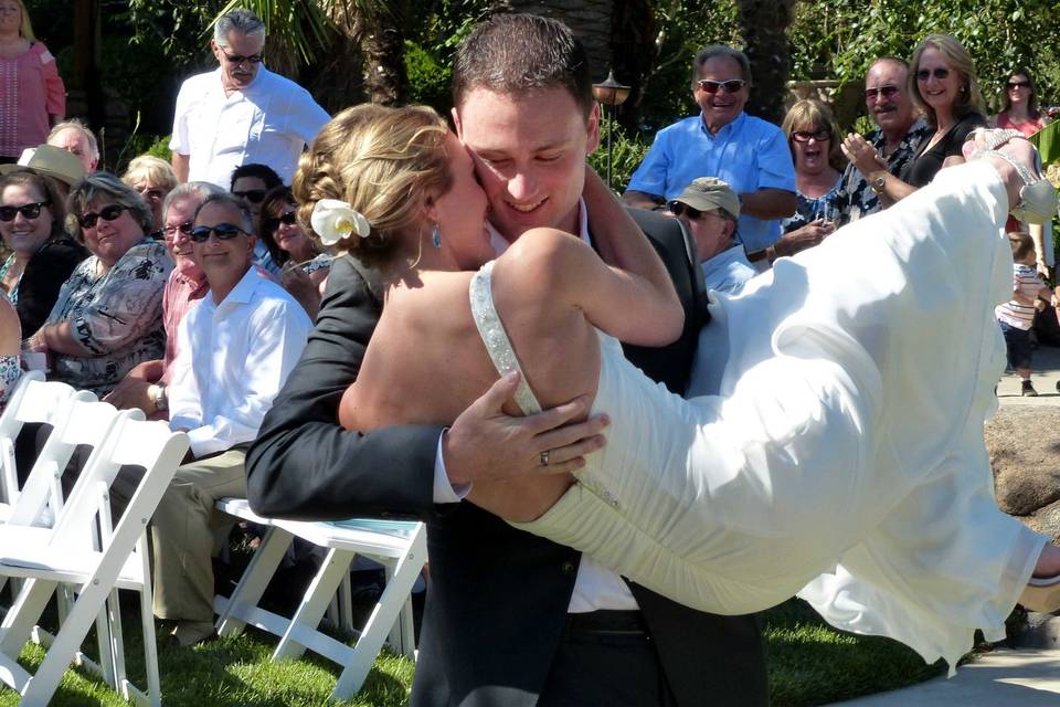 Groom carrying his bride