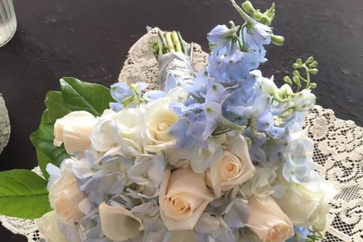 Calla lilies, white hydrangea, blue delphinium, vendella Roses,