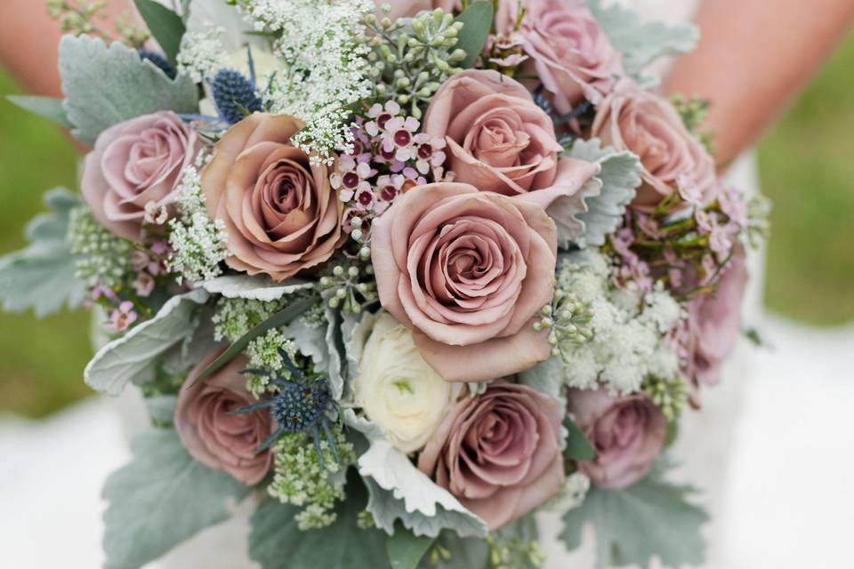 Amnesia Roses, White Ranunculus, lavender wax flower, queen anne’s lace, seeded eucalyptus, blue thistle  and dusty miller