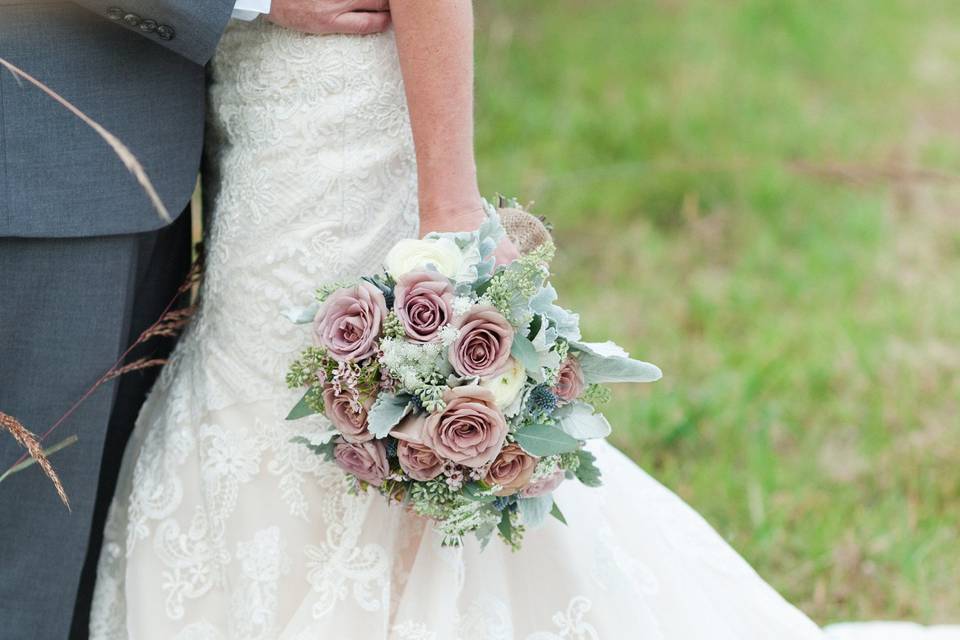 Amnesia Roses, White Ranunculus, lavender wax flower, queen anne’s lace, seeded eucalyptus, blue thistle and dusty miller