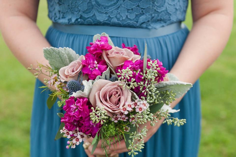 Bride’s Maid Bouquet with Amnesia Roses, Fuchsia Stock, Lavender Wax Flower, Seeded Eucalyptus, blue thistle, and Dusty Miller