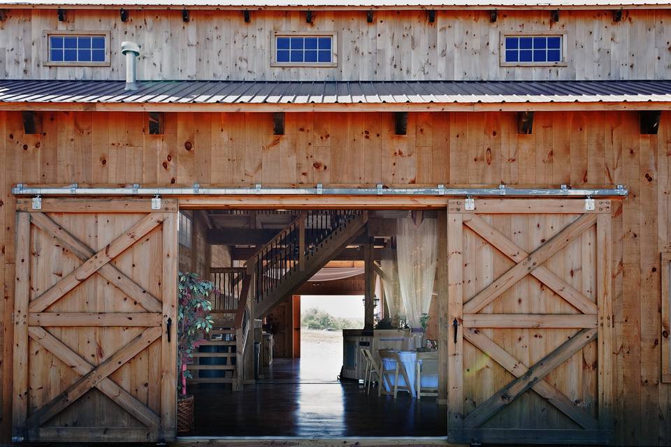 View peeking in through one of the slider doors on the north side of the barn.