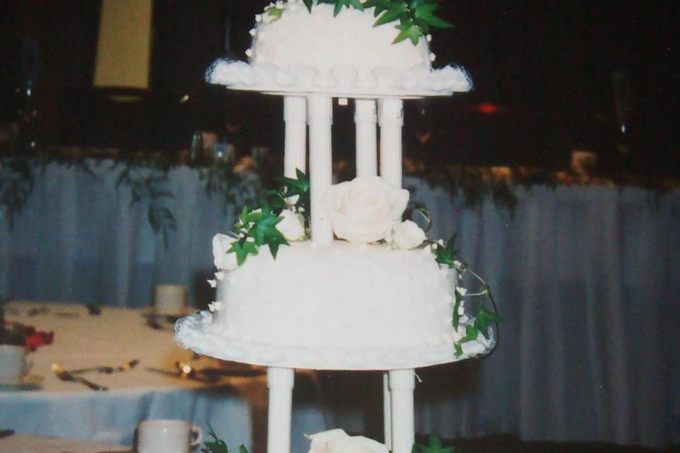 Four tier cake with green ribbon bands