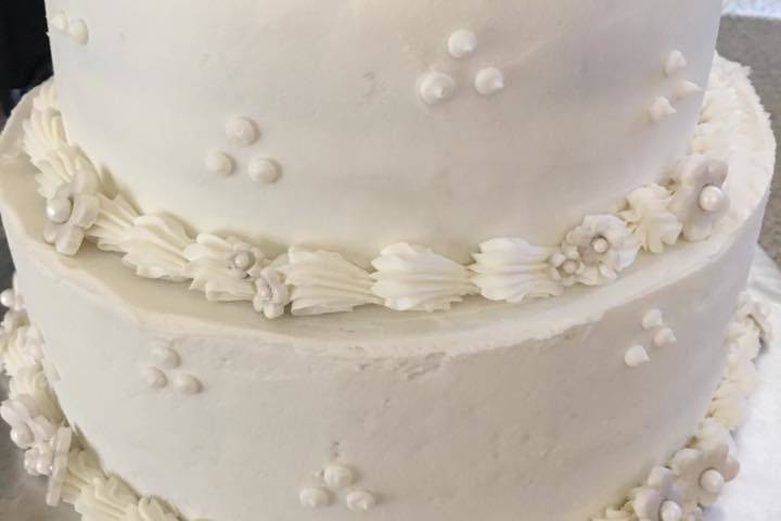 White cake topped with sugar flowers