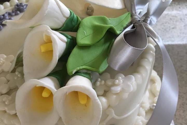 White cake topped with sugar flowers