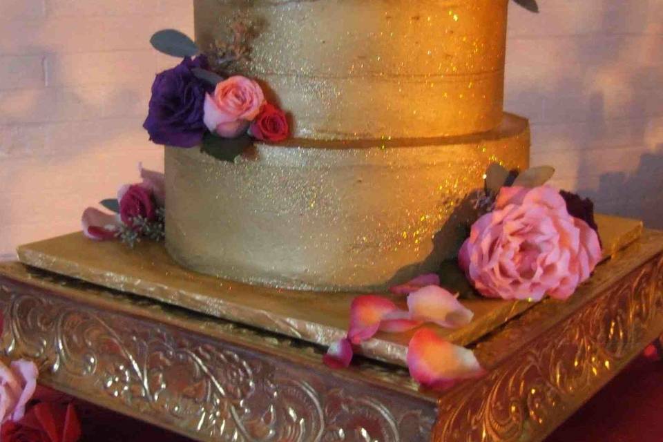 Gold Wedding Cake: Deep Chocolate Cake, Lingonberry Jam ribbon, Raspberry Ganache filling and frosting.