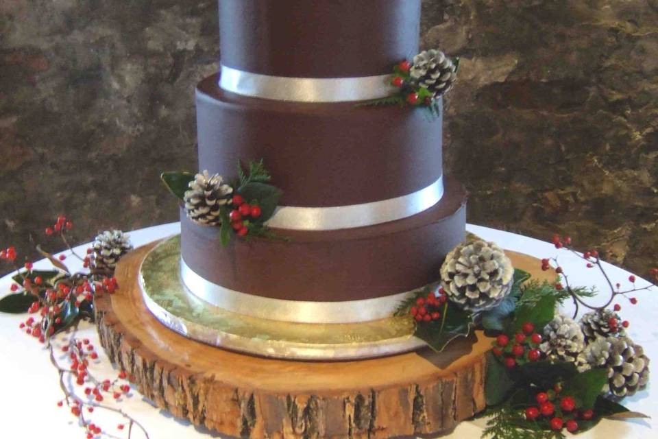 Holidays Ganache Wedding Cake: Bottom tier is White Cake, Midnight Ganache ribbon, Raspberry-Pomegranate Buttercream filling. Middle and top tiers are Deep Chocolate Cake, Midnight Ganache ribbon, toasted mini marshmallows, Salted Caramel Buttercream filling. All tiers frosted with Midnight Ganache.