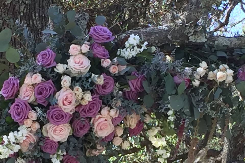 Arch built by family, we added fresh flowers for a perfect ceremony back drop