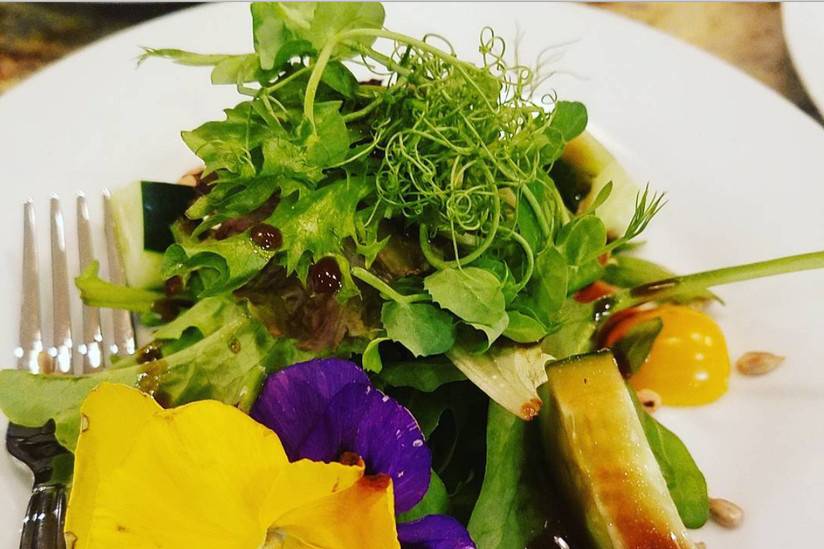 Mixed green salad with pea shoots and edible pansies