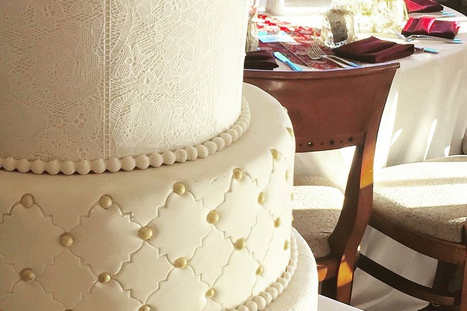 Close up of edible lace on fondant Winter wedding cake.