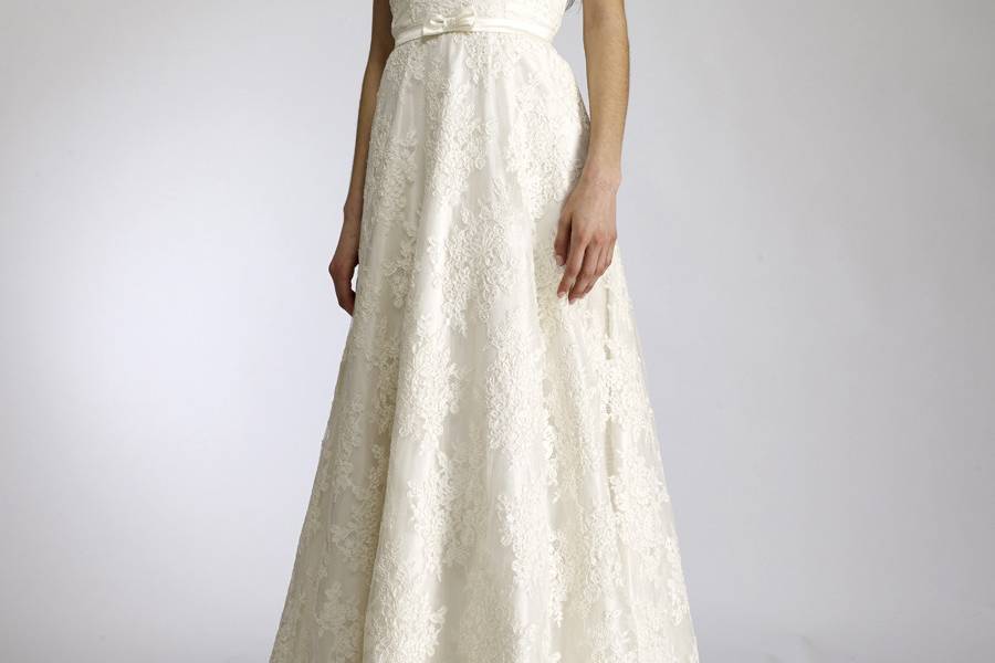 ClaireStrapless sweetheart neckline lace gown withdelicate silk organza ruffle peeking from hem.