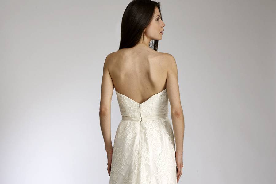 ClaireStrapless sweetheart neckline lace gown withdelicate silk organza ruffle peeking from hem.