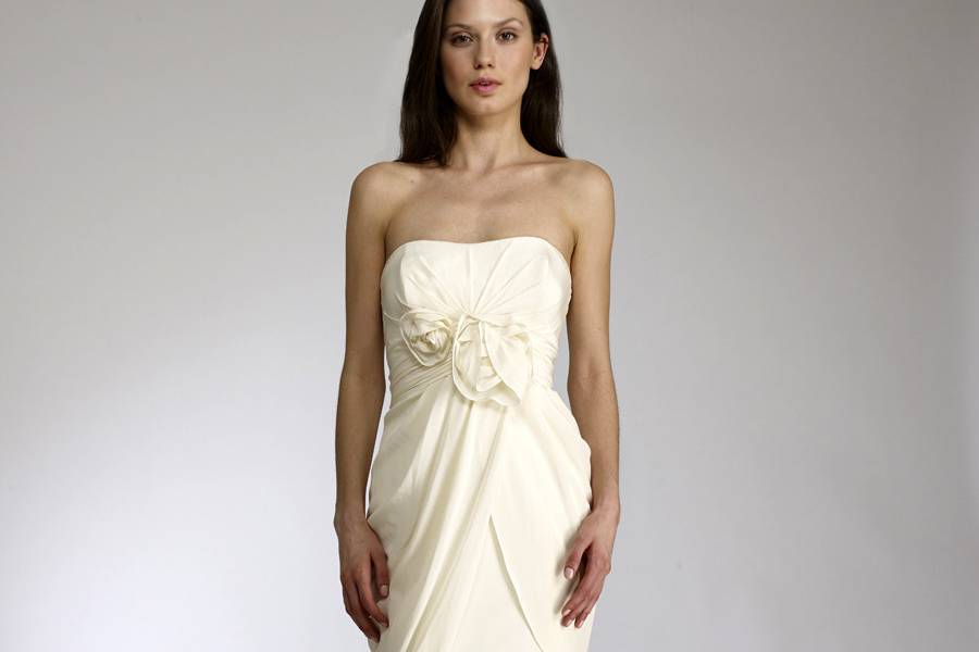 OlgaStrapless fit to flair gown of crepe de chine. The bodice is tucked and punctuated with two roses.