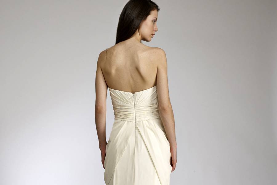 OlgaStrapless fit to flair gown of crepe de chine. The bodice is tucked and punctuated with two roses.
