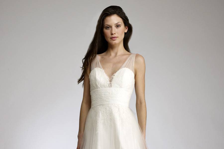 SkyeSoft frothy tulle v-neck ballgown with lightlybeaded lace appliqués.