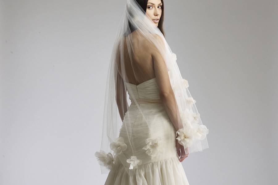 PenelopeEnglish Net trumpet gown with draped bodice and hand-cut Silk Organza floral appliques.
