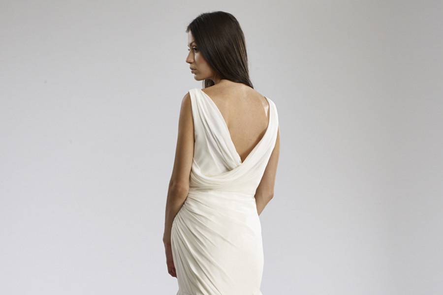 SylviaSilk Chiffon “V”-neck gown with dropped torso, cowl back and jeweled belt.