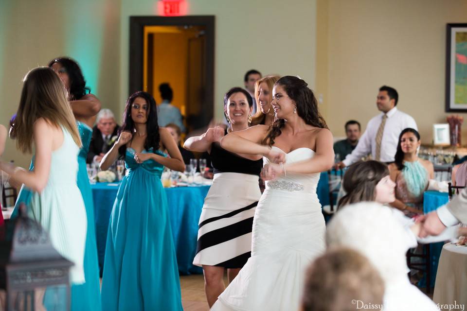 Bride and her bridesmaids dancing