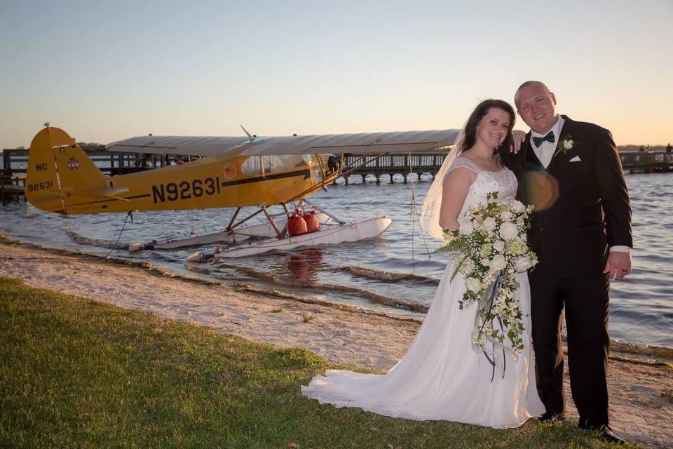 Bride and groom by the plane