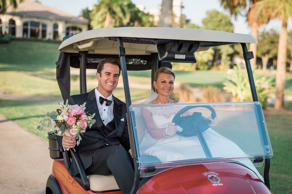 Newlyweds in a golf cart