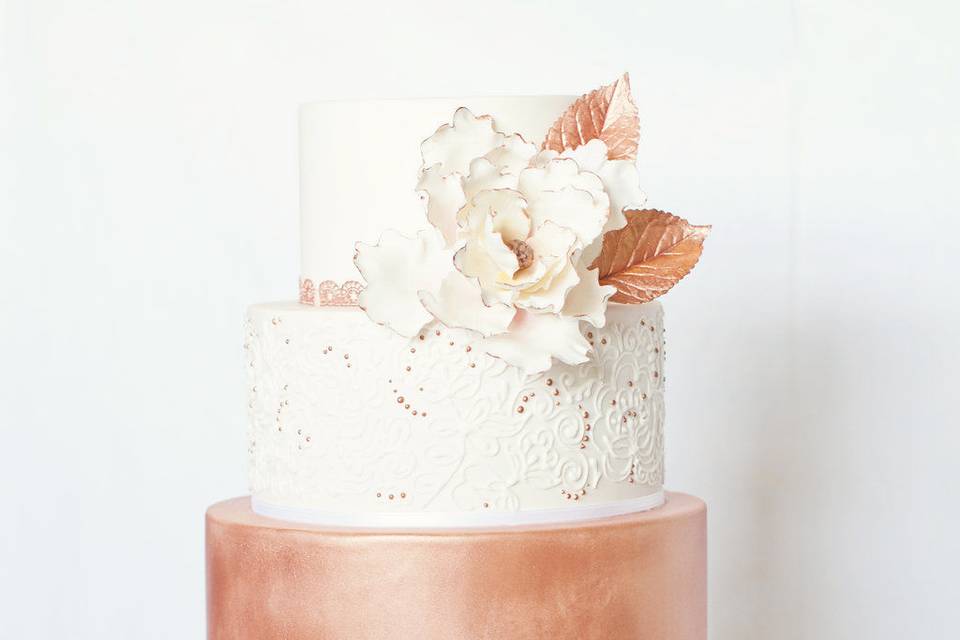 Four tier white and rose gold cake