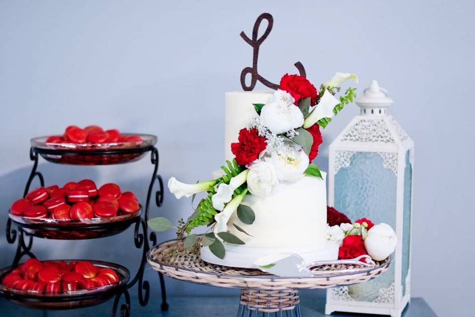 Two tier wedding cake with white and red flowers