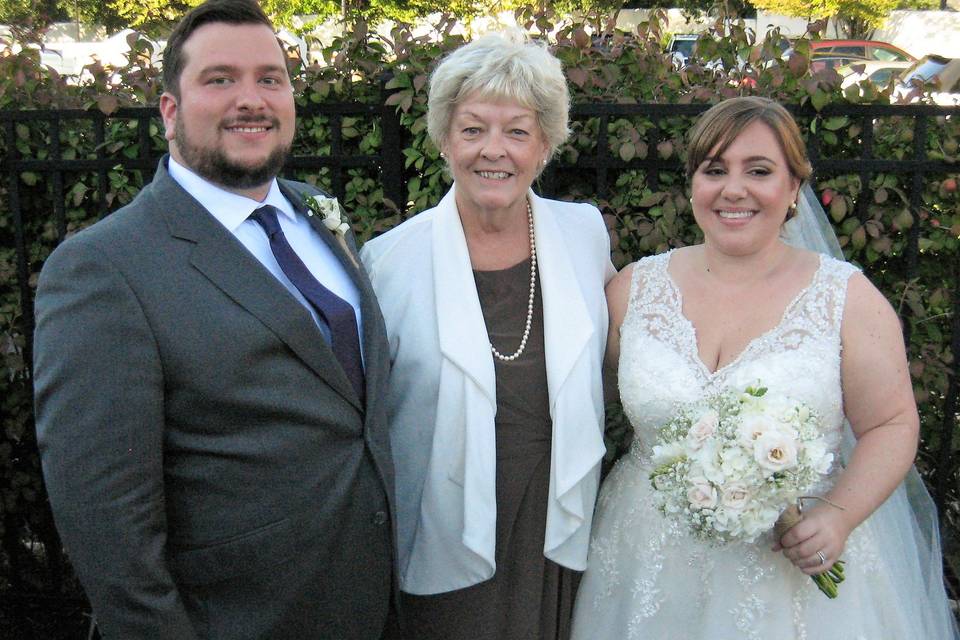 Groom, the officiant, and the bride