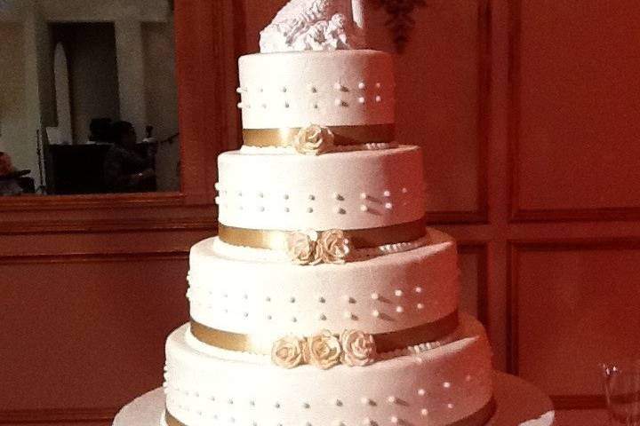 White cake with gold ribbons