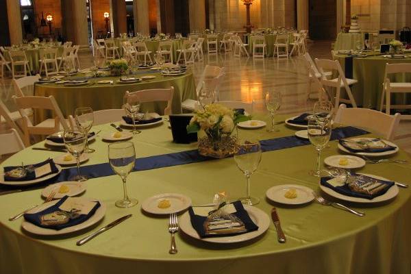 Round table setting with green linen