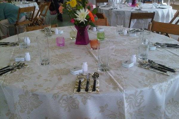 Round table setting with white linen
