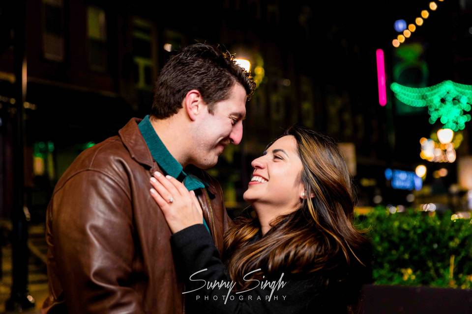 Engaged Couple Under Festive L