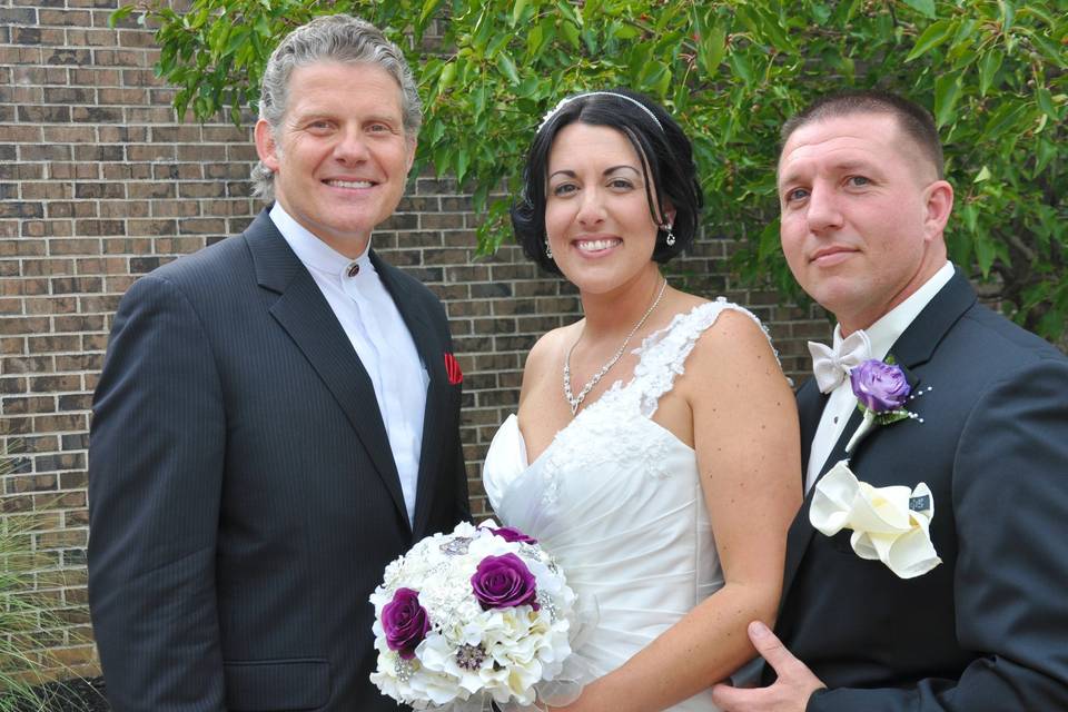 The reverend with the newlywed couple