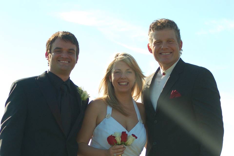 Bride and groom with the officiant