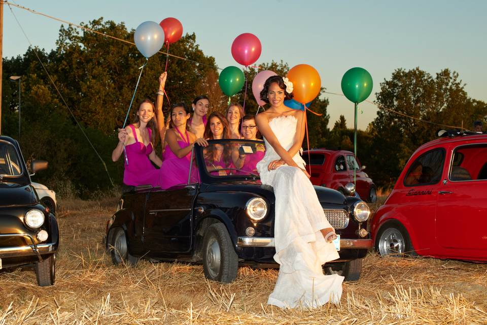 Bridal party by the cars