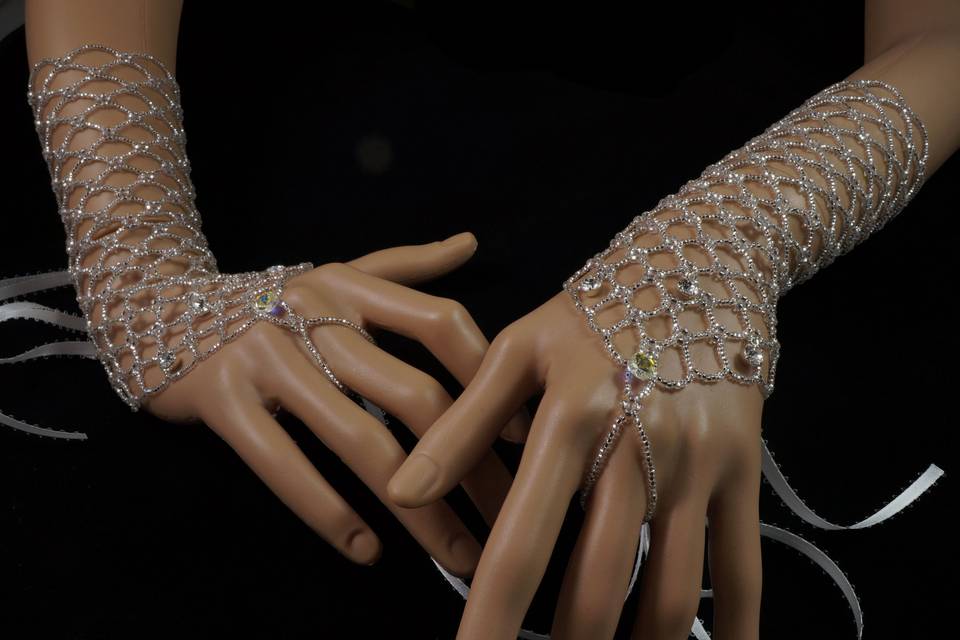 Stunning and unique beaded finger loop gloves.  No fabric backing! Structure is made with silver Czech glass alone. Drops of Swarovski crystal and Swarovski crystal pear pendants.
