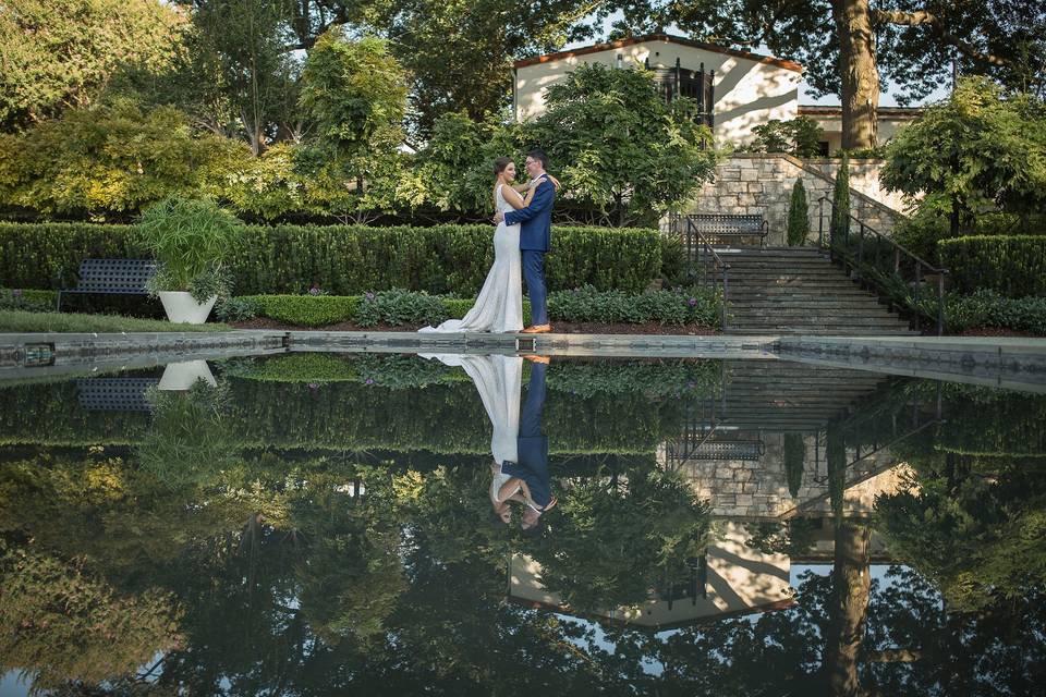 A beautiful reflection shot of the bride and groom after their ceremony. The Dallas Arboretum was the perfect backdrop for their day.