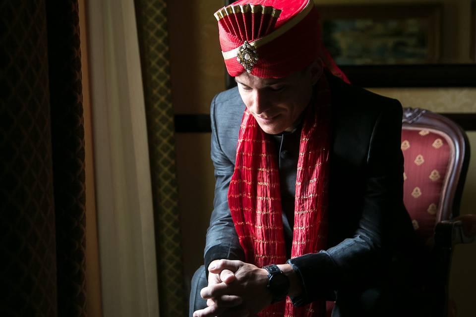 A pensive groom says a prayer of peace before the long day ahead.