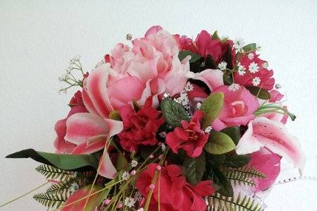 Hot pink stargaziers, azleas, babys breath, and peonies make this bouquet one you want to carry.  Small cascade for simple elegance.