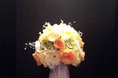 Spring time abounds when a flower girl carries this pomander, full of roses, daisies and ribbon galore!