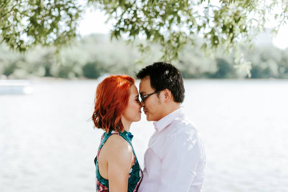 Engaged couple under tree.