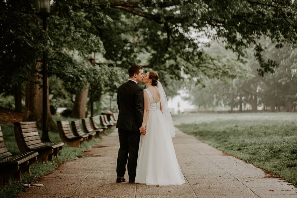 Bride groom kissing in park