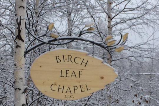 Venue sign and trees