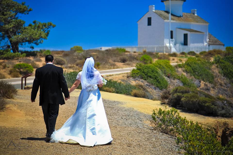 Newlywed couple walking towards the Point Loma Lighthouse, San Diego, CA