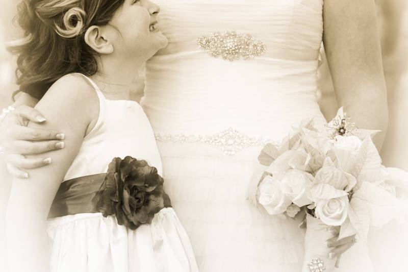 Old style, sepia photo of bride with her daughter the flower girl