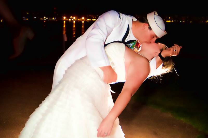 Navy groom embracing bride in the famous soldier/nurse pose from WWII