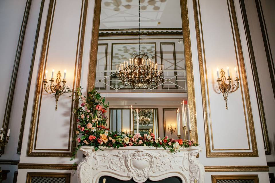 The fireplace in the Grand Salon decorated with beautiful arrangements