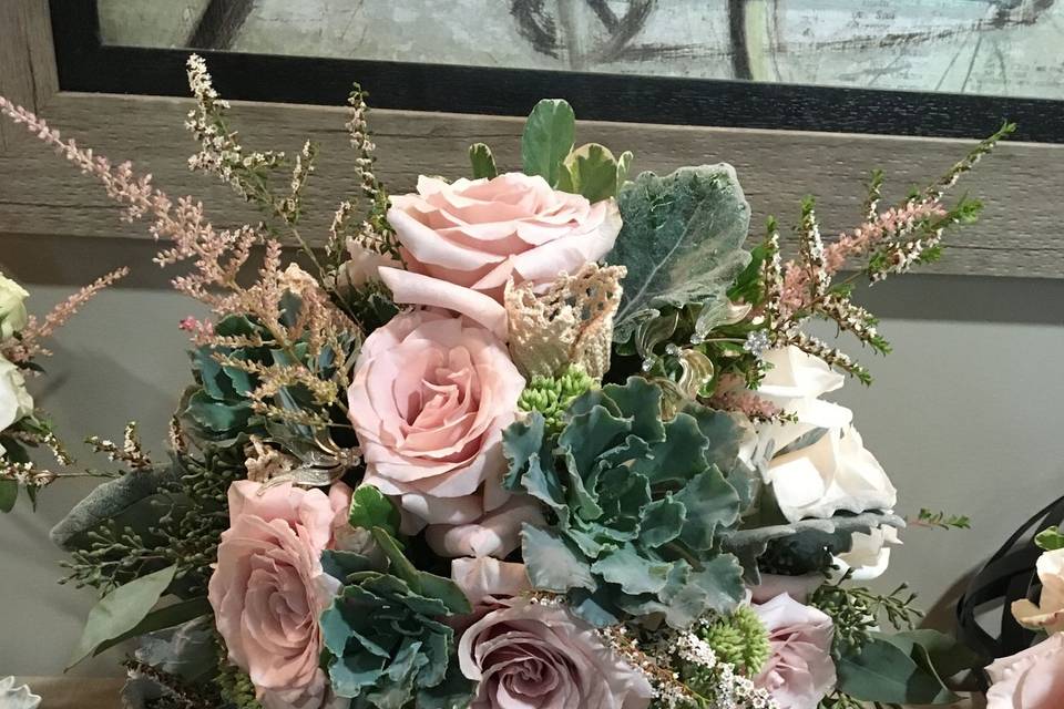 Gray Green succulents and  roses . a loosely styled cascade.