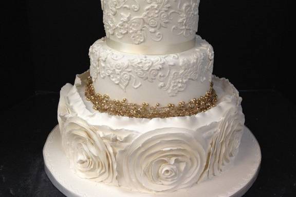 All white wedding cake with gold bits