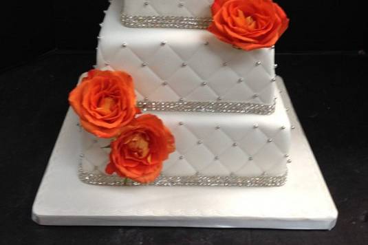 Square wedding cake with orange roses