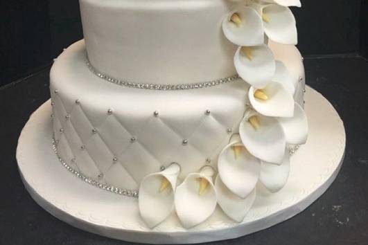 All white wedding cake with flowers